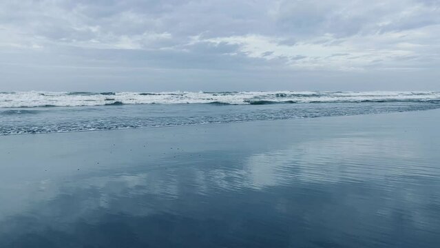 Foamy water sea wave come in to beach sand beautiful in sunny summer sun
