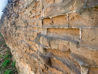 Close-up of a vintage brick wall with weathered bricks
