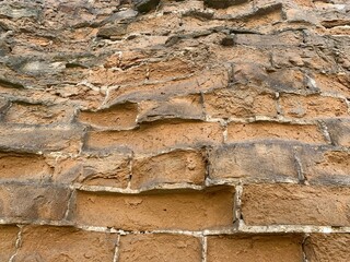 Close-up of a vintage brick wall with weathered bricks