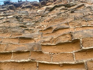 Close-up of a vintage brick wall with weathered bricks