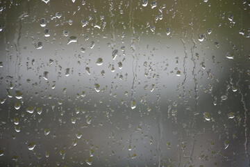 Close-up view of a window covered with raindrops