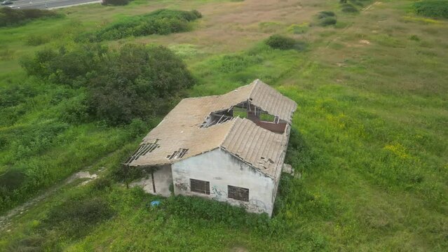 Aerial video above an abandoned building in an agricultural area in Tel Hanan, Israel