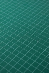 green cutting mat board background with line and scale measure guide pattern for object art design, tool equipment of diy craft work