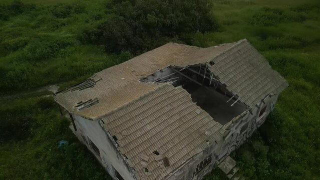 Aerial video above an abandoned building in an agricultural area in Tel Hanan, Israel