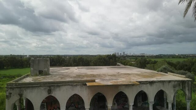Aerial video above an abandoned building in an agricultural area in Tel Hanan, Israel