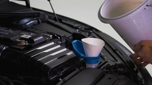 A man refilling his windscreen wiper fluid p2