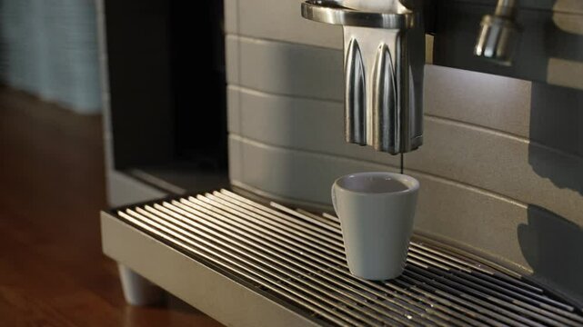 Coffee being poured in a cup by a coffeemachine