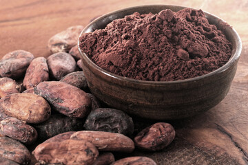 Cocoa powder and coffee beans on a wooden table