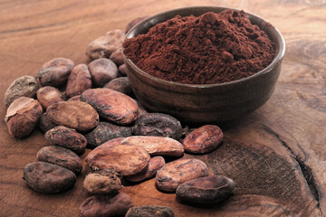 Cocoa powder and coffee beans on a wooden table