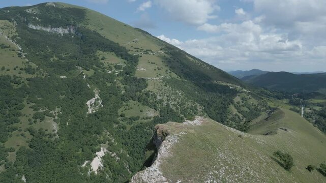 Soar above the majestic Italian mountains with this stunning drone footage. Enjoy breathtaking views of rugged peaks, lush valleys, and pristine natural beauty from a bird's-eye perspective. Nerone