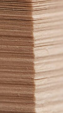 Slow motion of flicking through old book pages.
