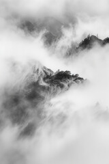 Fog forming abstract patterns as it moves through a landscape, symbolizing the ephemeral and transformative nature of creativity.