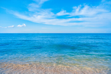 Nature of the beach and sea Summer with sunshine, sandy beaches, clear blue waters sparkling against the blue sky. On an island with good ecology and environment Background for summer vacation concept