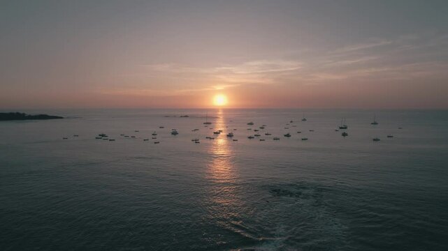 Drone view hundreds boats on Tamarindo beach Guanacaste during sunset  in Costa Rica.