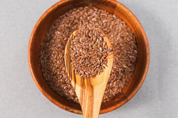 Flaxseed in the wooden spoon close-up, healthy diet, nutrient rich ingredient