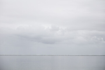 Dark storm clouds over a quiet ocean