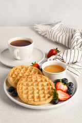 Waffles for breakfast with berries and a cup of coffee
