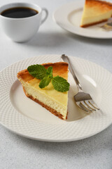 Slice of New York cheesecake on a concrete Light background