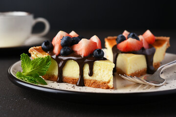 Cheesecake slice with berries and chocolate sauce
