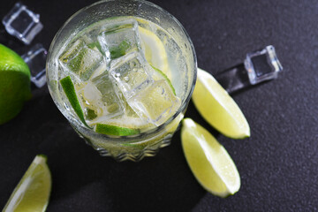 Cold mojito with tonic and lime on a dark background