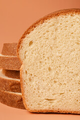 Sliced ​​slices of white bread on a pink background