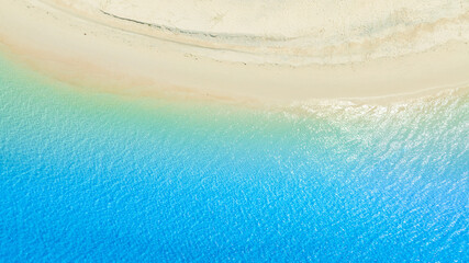 Top view beach sand background for summer vacation concept. Beach nature and summer seawater with sunlight light sandy beach Sparkling sea water