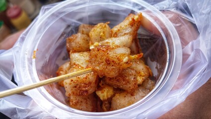 Cilor or Aci Telor in plastic cup with bamboo stick.