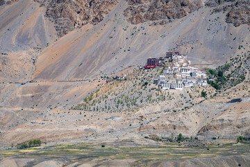 Picturesque Kee Monastery atop hill, grand mountains in distance, Spiti Valley, India
