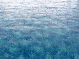 Raindrops on blue pool water. Background