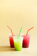 Colored summer freshness lemonades on beige background