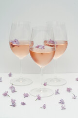 Three glasses of rosé with flowers.