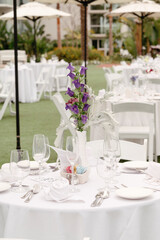 Purple flowers on outdoor table for brunch