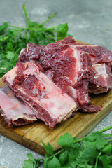 Iga sapi mentah or raw beef ribs  on preparation for cooking with some spice. Beef ribs on chopping board with wooden rustic background.