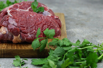 Daging sapi mentah or raw beef on preparation for cooking with some spice. Beef on Eco friendly package and chopping board with wooden rustic background.