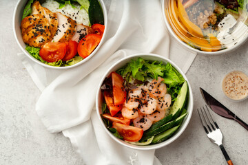 Beautiful composition with poke bowls on gray background with napkin