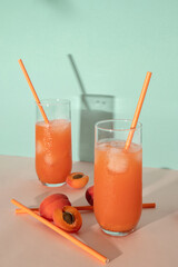 Apricot summer fruit drinks on peach and blue background