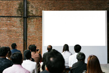 Front view of mockup blank white screen in vintage hall and audiences. Business and Entrepreneurship concept.