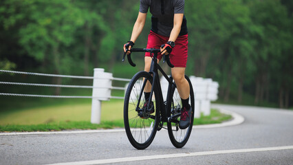 Fototapeta premium Asian woman cycling on summer trail