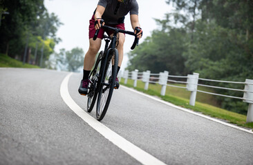 Naklejka premium Woman cycling on summer trail