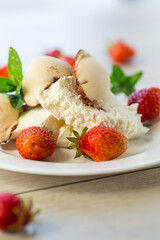 fresh organic cottage cheese with strawberries and ice cream in a plate on a wooden table