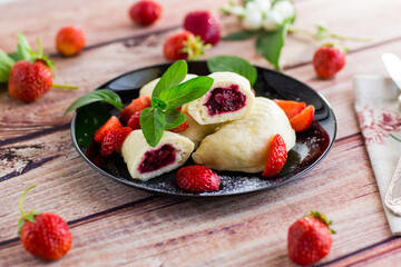 cooked sweet homemade steamed dumplings with strawberries