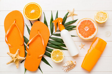 Top view composition of flip flops placed with beach accessories top view on table background....