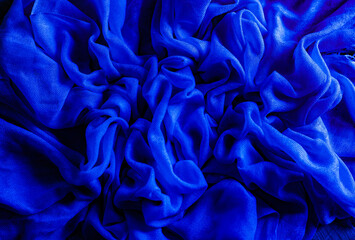 Soft fabric. Blue fabric wrinkled, interesting abstract pattern. Wallpapers and backgrounds with copy space for text,