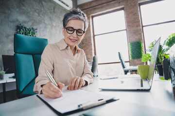 Photo of attractive good mood age lady agent dressed formal shirt siging contract indoors workplace...