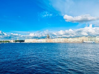 Fototapeta premium Fantastic white clouds at the city river, city river view, summer day