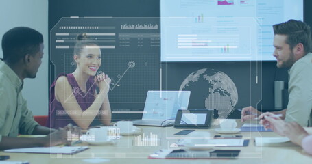 Image of interface with data processing against diverse colleagues discussing at office