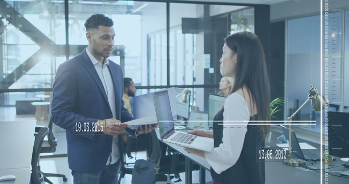 Image of moving lines with changing dates over diverse coworkers discussing reports in office