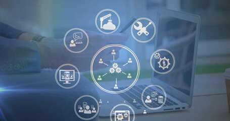 Image of multiple digital icons spinning over mid section of man using smartphone at office