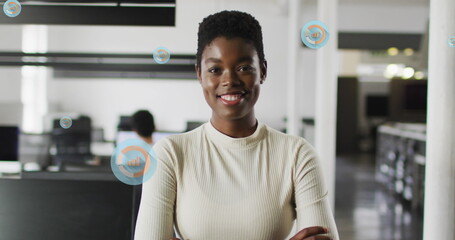 Image of network of connections with icons over biracial businesswoman using smartphone