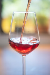 red wine pouring into glass